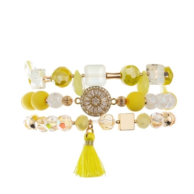 Paquet empilable élastique jaune de bracelet tissé par Boho de gland pendant des années de l'adolescence